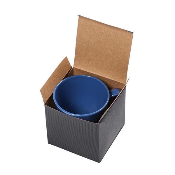 Top view of an open black square box with a blue ceramic mug inside of it against a white background