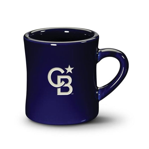 Closeup side view product image of a shiny glazed cobalt blue handled mug against a white background with the letters C and B and a star etched into the glaze in white