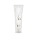 Closeup product image of a plastic bottle tube standing on its white cap on a white table. The tube has a white label with the word Wynn and Lemon & Verbena