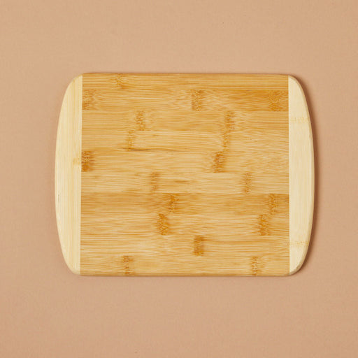 Top view product image of a bamboo cutting board rectangle shaped with rounded corners and light bamboo color at the ends